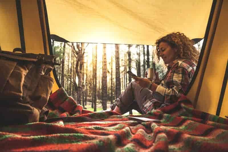 camper sitting on floor tent carpet